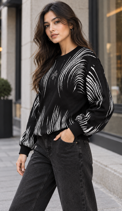 Woman wearing black brushstroke rhinestone sweater by Purple Imli in a city street look