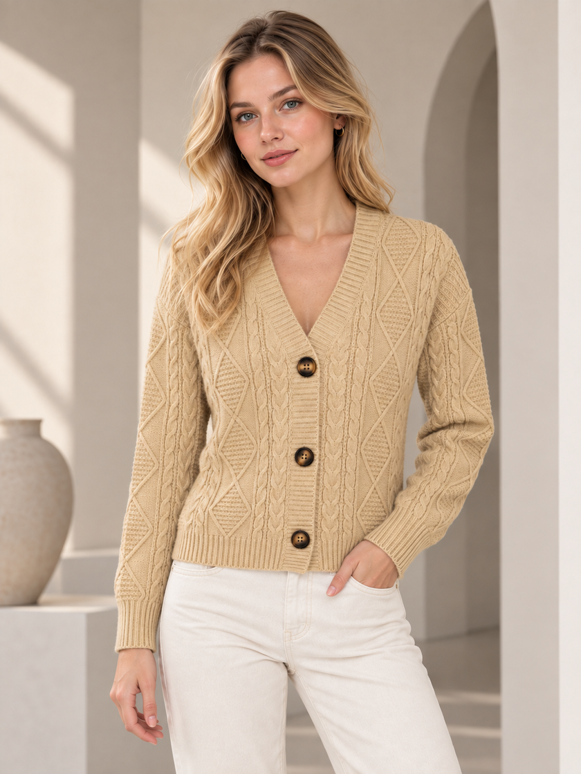 Woman wearing beige cable knit V-neck cardigan by Purple Imli in a city street look