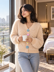Woman wearing beige fuzzy daisy button cardigan by Purple Imli in a city street look