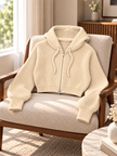 Close-up detail of beige cropped ribbed zip women's hoodie by Purple Imli