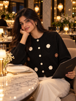 Woman wearing black crochet flower cardigan by Purple Imli in a city street look