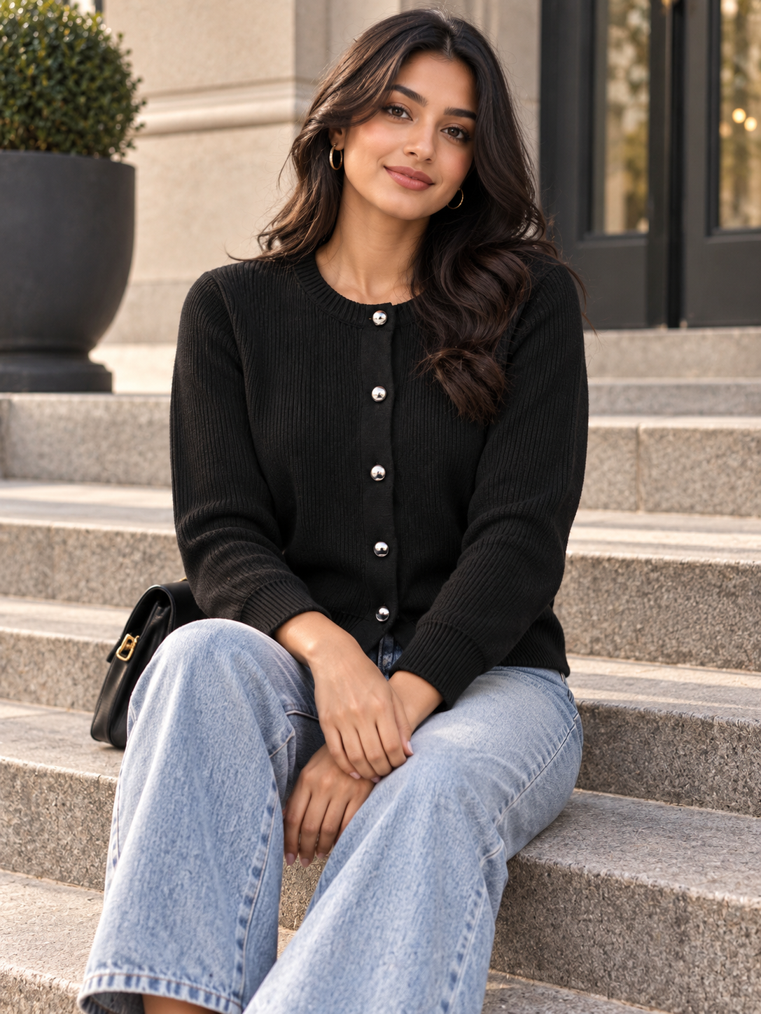 Woman wearing black classic button cardigan by Purple Imli in a city street look