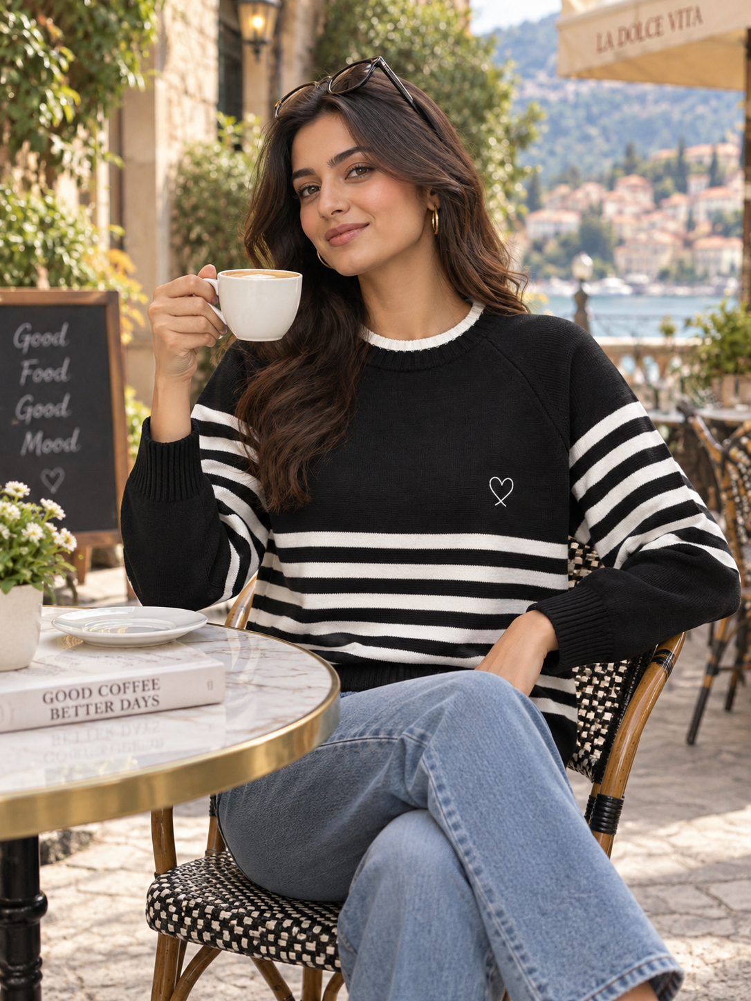 Woman wearing black striped raglan sweater by Purple Imli in a city street look