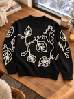 Close-up detail of black outline leaf women's sweater by Purple Imli