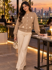 Woman wearing camel brown crochet flower cardigan by Purple Imli in a city street look