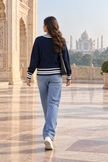 Dark blue varsity cable knit V-neck women's sweater by Purple Imli – back view