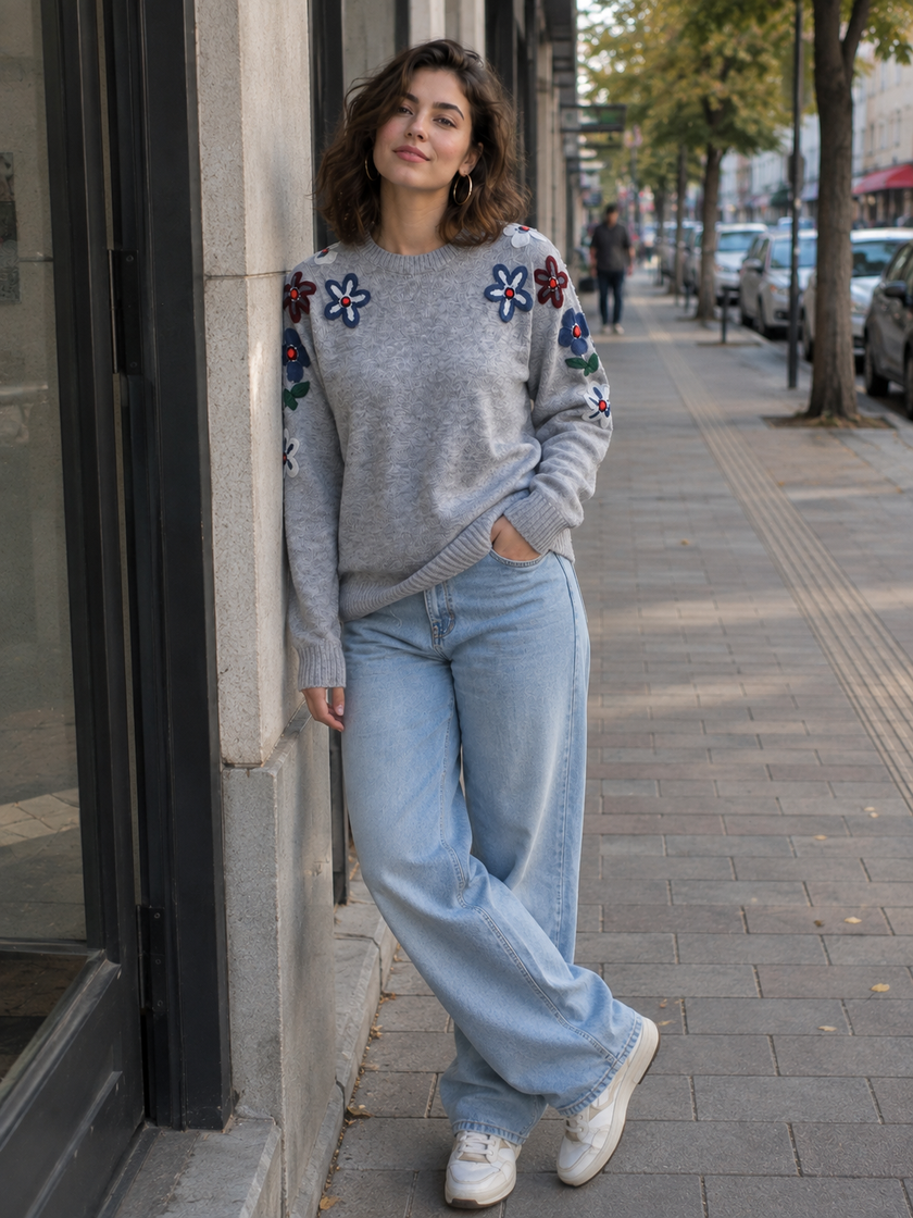 Woman wearing grey embroidered round-neck sweater by Purple Imli in a city street look