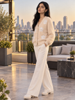 Woman wearing light beige fuzzy pearl flower V-neck cardigan by Purple Imli in a city street look