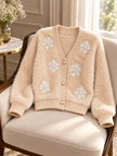 Close-up detail of light beige fuzzy pearl flower V-neck women's cardigan by Purple Imli