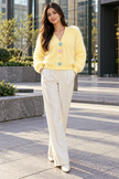Light yellow fuzzy daisy button women's cardigan by Purple Imli – front view
