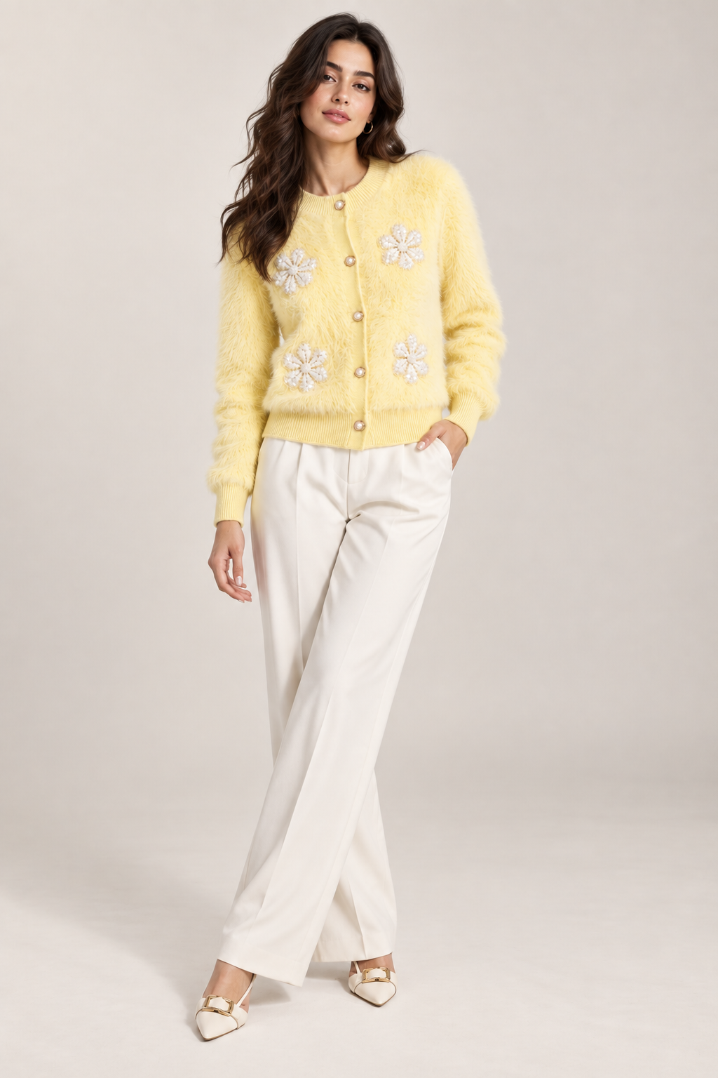 Woman wearing light yellow fuzzy pearl flower cardigan by Purple Imli in a city street look