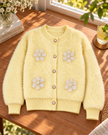 Close-up detail of light yellow fuzzy pearl flower women's cardigan by Purple Imli
