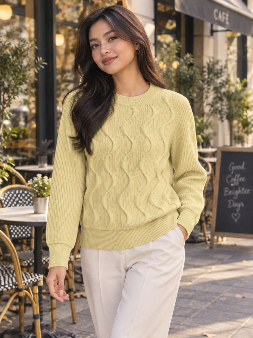 Woman wearing light yellow wave cable knit sweater by Purple Imli in a city street look