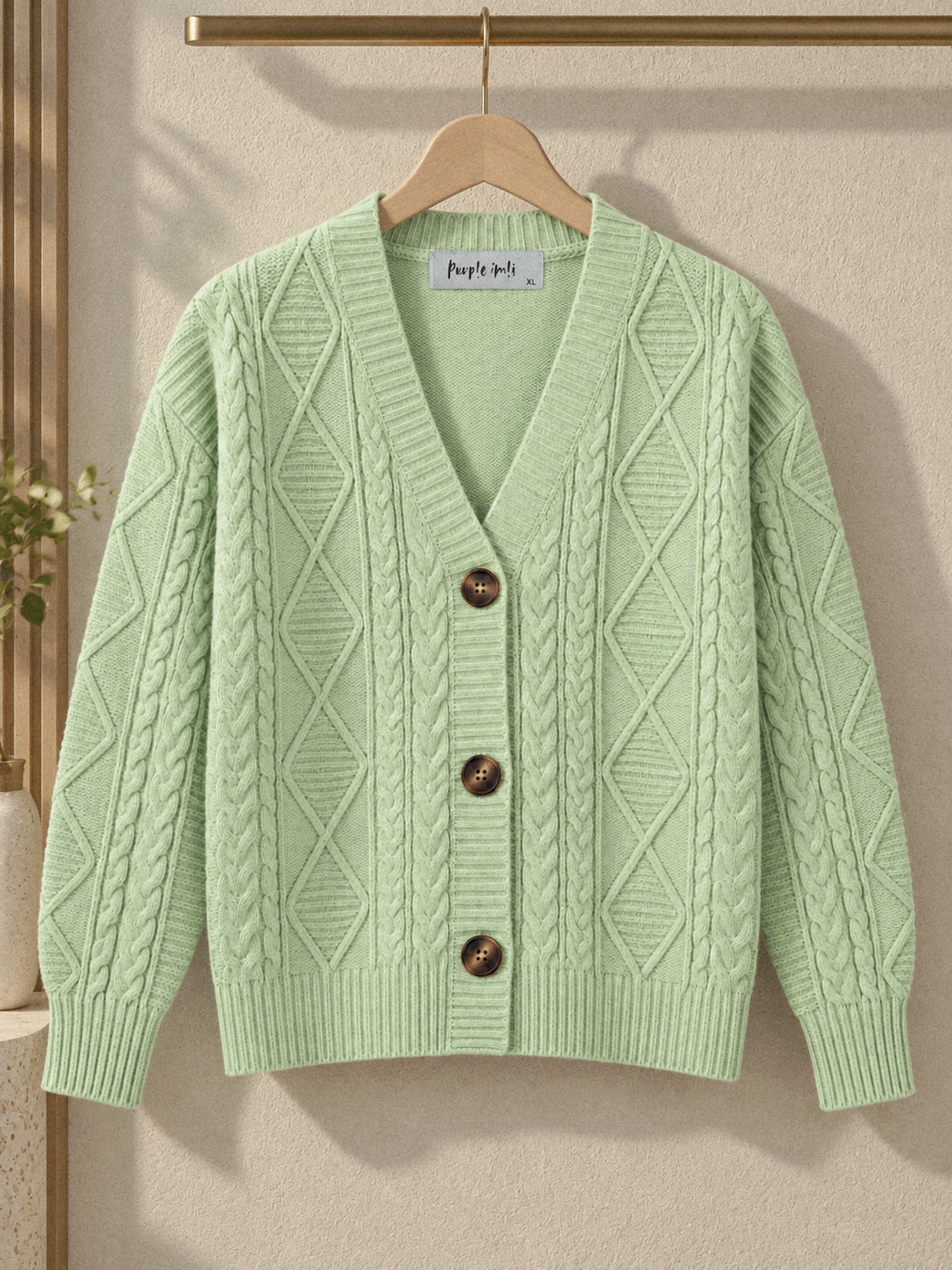 Close-up detail of pista green cable knit V-neck women's cardigan by Purple Imli