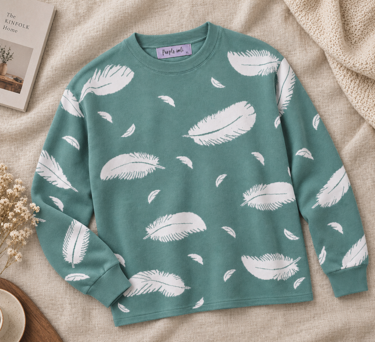 Close-up detail of teal green feather print women's sweater by Purple Imli