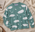 Close-up detail of teal green feather print women's sweater by Purple Imli