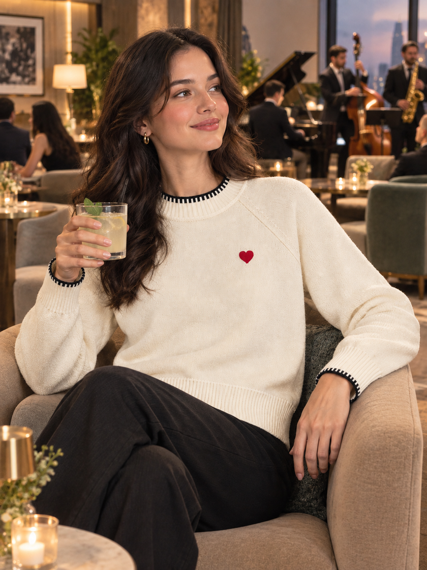 Woman wearing cream little heart crew-neck sweater by Purple Imli in a city street look